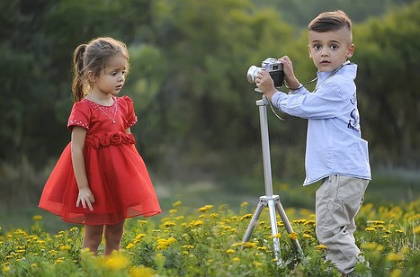 Kids In A Field Taking Photographs